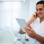 doctor-holding-digital-tablet-while-talking-mobile-phone_107420-73959