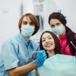 happy-dentists-with-patient_1153-649
